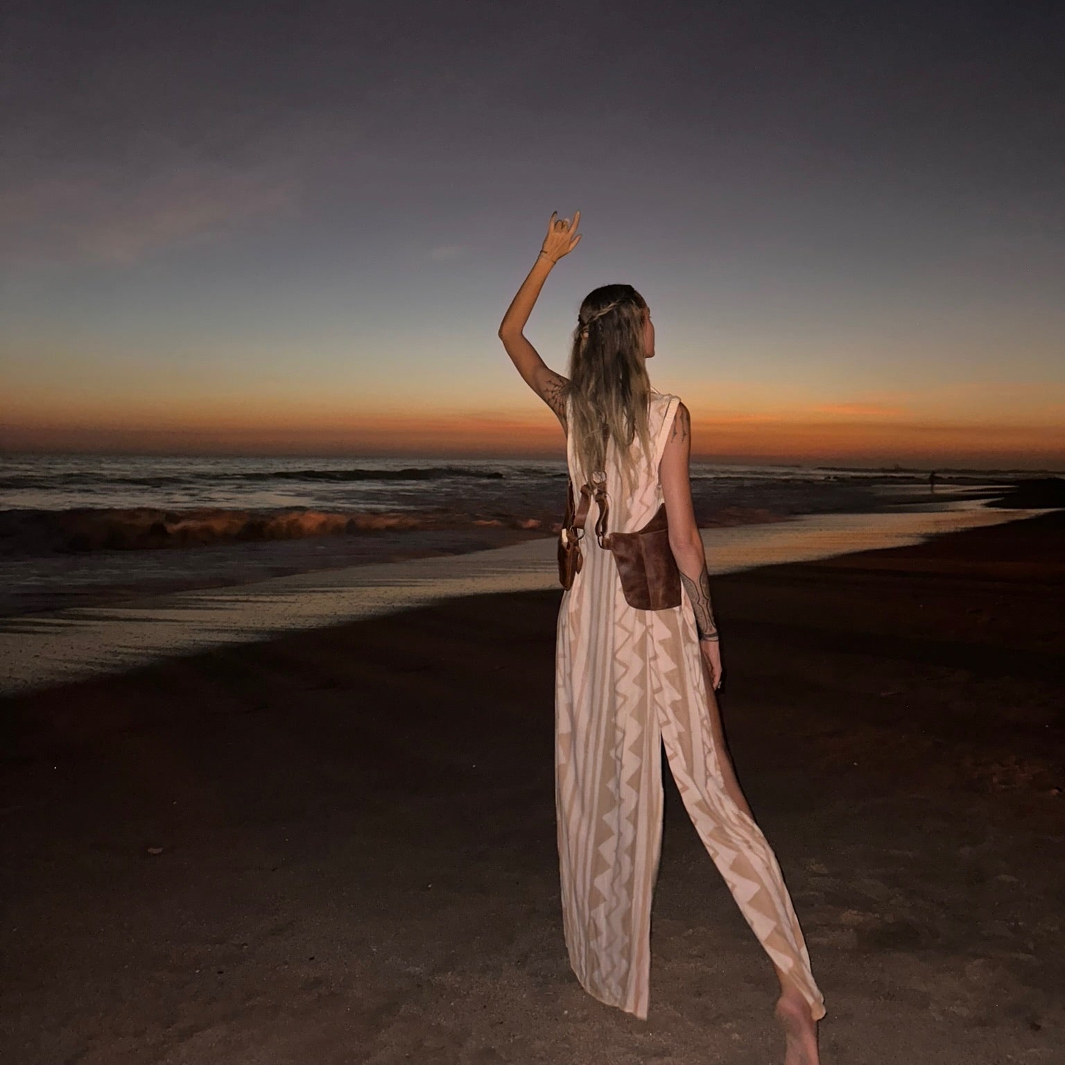 Woman standing on a beach at sunset, facing the ocean. leather bag leather holster bag leather saddle bag unisex leather handbag 